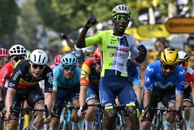 Biniam Girmay cycles to the finish line